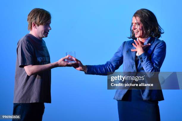 Ulrike Folkerts as Cookie Close and Sven Prietz as Dan can be seen on stage during a photo rehearsal of the theatre piece "Fuer immer schoen" at the...