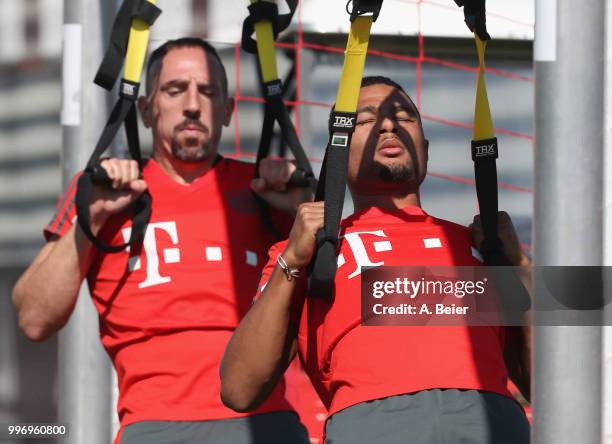 Franck Ribery and Serge Gnabry of FC Bayern Muenchen practice during a training session at the club's Saebener Strasse training ground on July 12,...