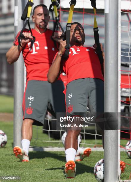 Franck Ribery and Serge Gnabry of FC Bayern Muenchen practice during a training session at the club's Saebener Strasse training ground on July 12,...