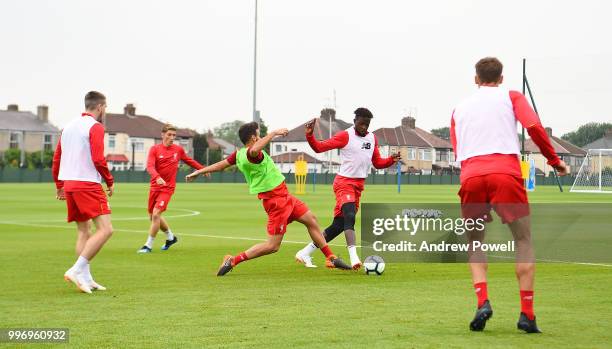 Divock Origi and Pedro Chirivella of Liverpool during a training session at Melwood Training Ground on July 12, 2018 in Liverpool, England.