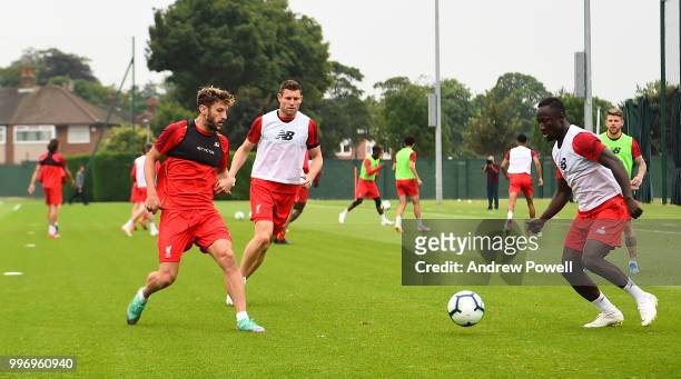 Adam Lallana and Naby Keita of Liverpool during a training session at Melwood Training Ground on July 12, 2018 in Liverpool, England.