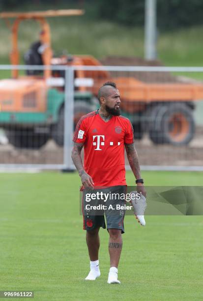 Arturo Vidal of FC Bayern Muenchen leaves the pitch in front of a excavator after a training session at the club's Saebener Strasse training ground...