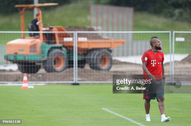 Arturo Vidal of FC Bayern Muenchen leaves the pitch in front of a excavator after a training session at the club's Saebener Strasse training ground...