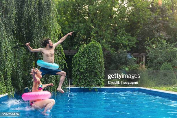 paare, die spaß in einem schwimmbad sommertag - lisegagne stock-fotos und bilder