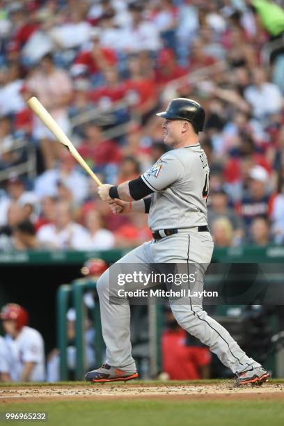 Justin Bour of the Miami Marlins takes a swing during a baseball game against the Washington Nationals at Nationals Park on July 5, 2018 in...