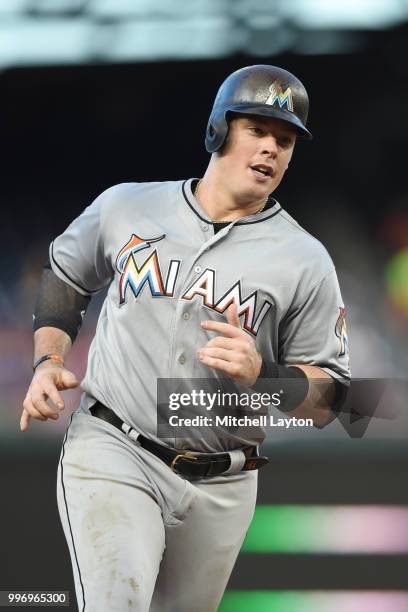 Justin Bour of the Miami Marlins runs ti third base during a baseball game against the Washington Nationals at Nationals Park on July 5, 2018 in...