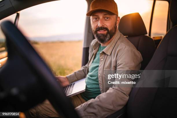 landwirt mit laptop in seinem auto - mixetto stock-fotos und bilder