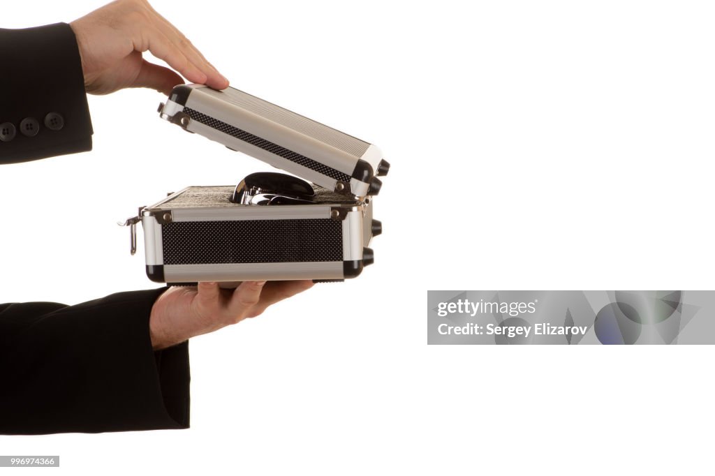 Hands of the man open metal case