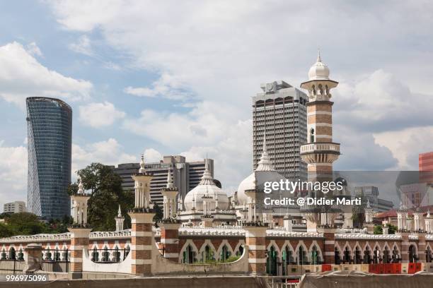 the friday mosque, or masjid jamek, in front of bank buildings in kuala lumpur, malaysia capital city - didier marti stock pictures, royalty-free photos & images