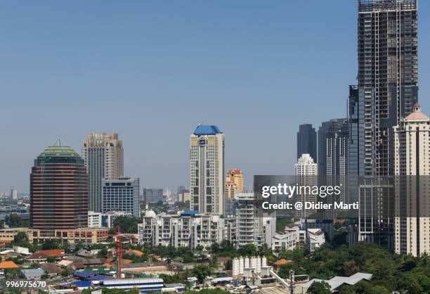 tall condominium tower in construction in the semanggi business district in jakarta on a sunny day in indonesia - didier marti stock pictures, royalty-free photos & images