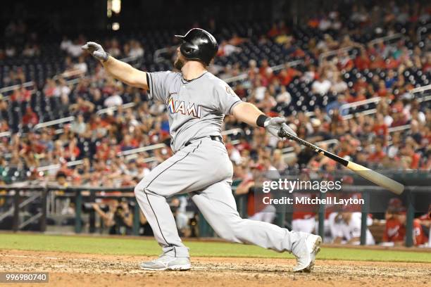 Bryan Holaday of the Miami Marlins takes a swing during a baseball game against the Washington Nationals at Nationals Park on July 5, 2018 in...