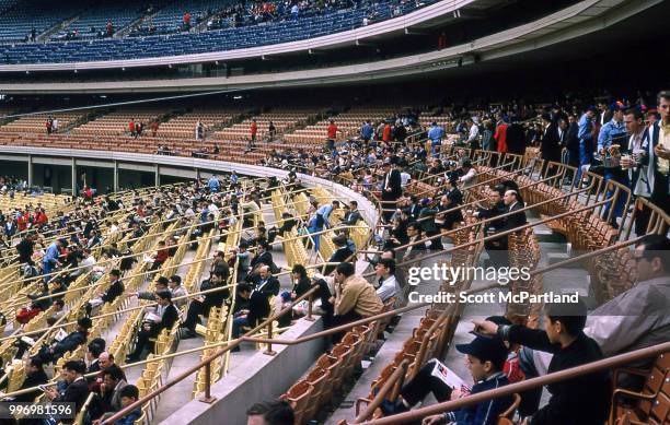 View of spectators in the stands of opening day at Shea Stadium, New York, New York, April 17, 1964. The day marked both the opening day of the...