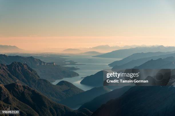 sunset over lake te anau, new zealand - te anau stock pictures, royalty-free photos & images