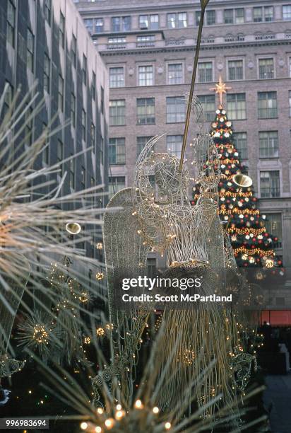 View of angel statues, adorned with Christmas lights, on the promenade at Rockefeller Center in midtown Manhattan, New York, New York, December 1,...