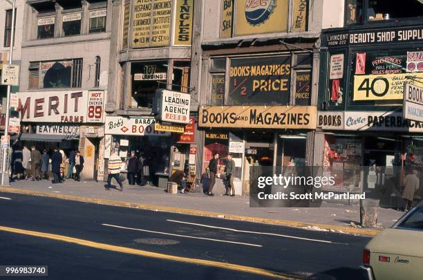 View of book stores, employment agencies, and beauty supply shops line 42nd Street in Manhattan's Times Square, New York, New York, March 1, 1970.