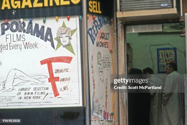 View of patrons through the open door of the 'Peeporama' sex shop on 42nd street in Manhattan's Times Square, New York, New York, March 1, 1970. A...