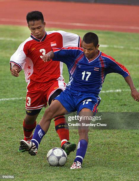 Sarawut Trephan of Thailand is challenged by Mohammad Johaness of Singapore during a Group A match between Thailand and Singapore held at the MPPJ...