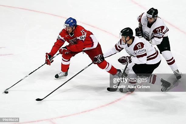 Jan Marek of Czech Republic is challenged by Guntis Galvins and Maris Jass of Latvia during the IIHF World Championship group F qualification round...