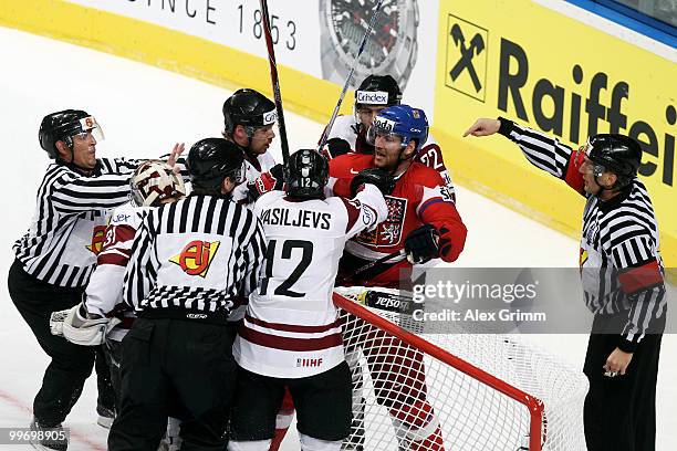 Jiri Novotny of Czech Republic fights with players of Latvia during the IIHF World Championship group F qualification round match between Czech...