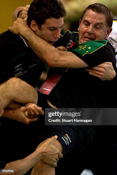 Grant Hackett of Australia struggles to throw National Swim Coach Don Talbot into the pool as Talbot retired after tonights event at the Chandler...