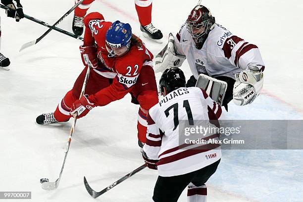 Lukas Kaspar of Czech Republic is challenged by Georgijs Pujacs and goalkeeper Edgars Masalskis of Latvia during the IIHF World Championship group F...