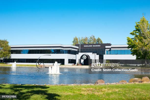 Landscaping and sign with logo at headquarters of the Oakland Raiders football team on Bay Farm Island, Alameda, California, July 9, 2018.
