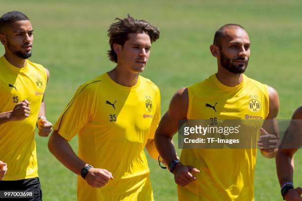 Goalkeeper Marwin Hitz of Dortmund and Oemer Toprak of Dortmund run during a training session on July 7, 2018 in Dortmund, Germany.