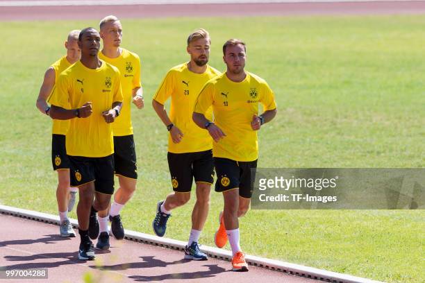 Abdou Diallo of Dortmund, Marius Wolf of Dortmund, Marcel Schmelzer of Dortmund and Mario Goetze of Dortmund run during a training session on July 7,...