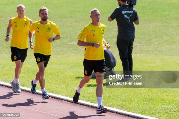 Sebastian Rode of Dortmund, Marcel Schmelzer of Dortmund and Marius Wolf of Dortmund run during a training session on July 7, 2018 in Dortmund,...