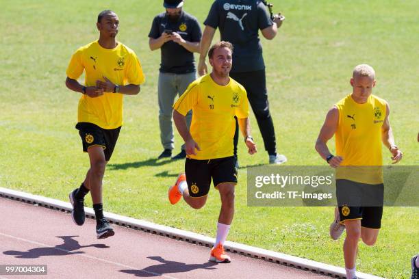 Abdou Diallo of Dortmund and Mario Goetze of Dortmund run during a training session on July 7, 2018 in Dortmund, Germany.
