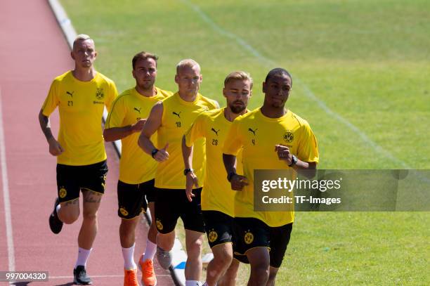 Marius Wolf of Dortmund, Mario Goetze of Dortmund, Sebastian Rode of Dortmund, Marcel Schmelzer of Dortmund and Abdou Diallo of Dortmund run during a...