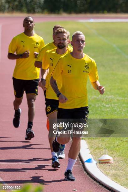 Abdou Diallo of Dortmund, Marcel Schmelzer of Dortmund and Marius Wolf of Dortmund run during a training session on July 7, 2018 in Dortmund, Germany.