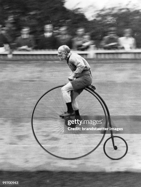 London's oldest cyclist: At the Penny-Farthing race near by London a 88 year old man won the race. England, London. Photograph. September 1931.