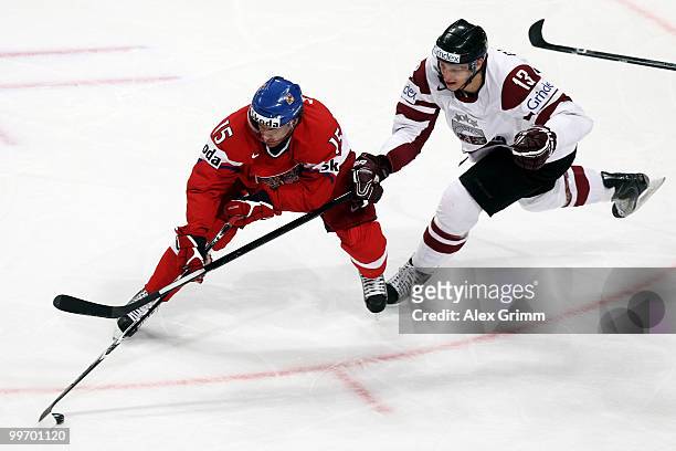 Aleksandrs Jerofejevs of Czech Republic is challenged by Guntis Galvins of Latvia during the IIHF World Championship group F qualification round...