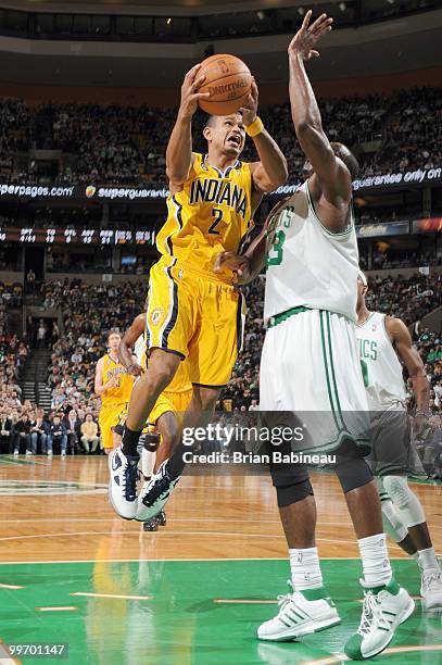 Earl Watson of the Indiana Pacers drives the lane against Kendrick Perkins of the Boston Celtics on March 12, 2010 at the TD Garden in Boston,...