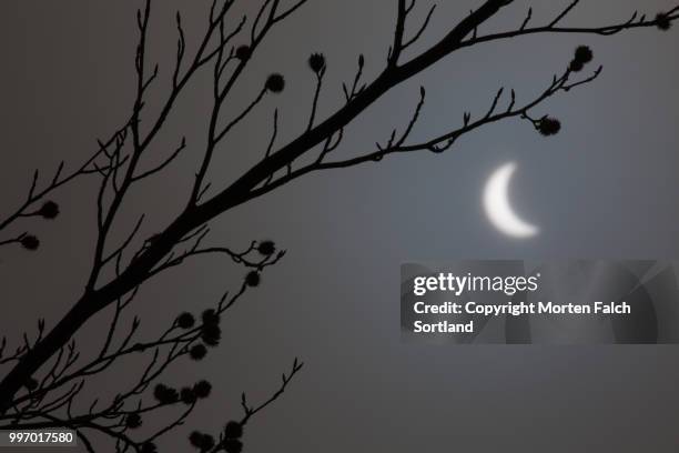 solar eclipse over norway in 2015. - sliver stock pictures, royalty-free photos & images