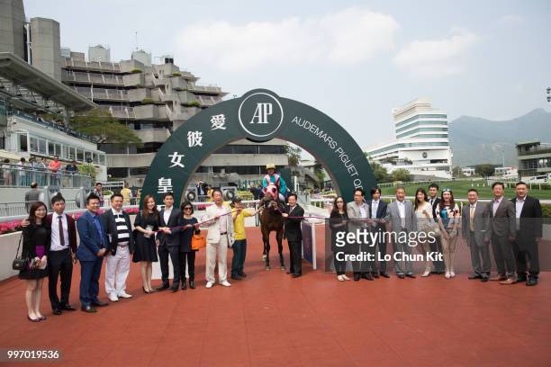Jockey Keith Yeung Ming-lun and owners celebrate after Indigo Way winning Race 3 Audemars Piguet Millenary Handicap at Sha Tin racecourse on April 26...