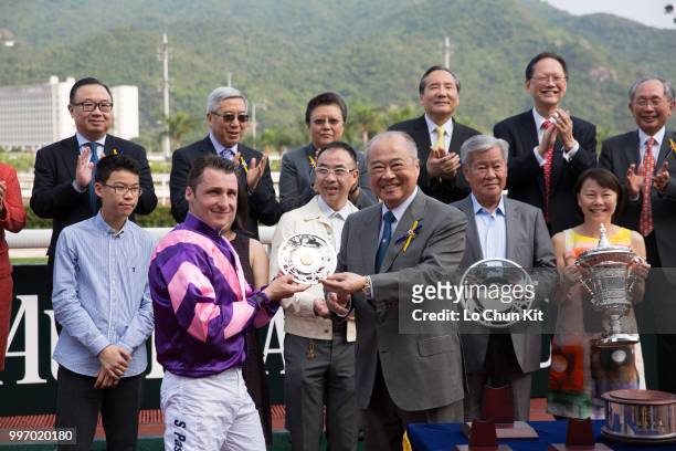 At the trophy presentation ceremony, HKJC Steward The Hon Sir C K Chow presents the Sprint Cup silver dishes to Dundonnell’s jockey Stephane Pasquier...