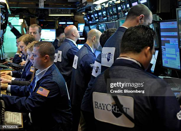 Traders work on the floor of the New York Stock Exchange in New York, U.S., on Monday, May 17, 2010. U.S. Stocks slid, led by energy shares, as the...