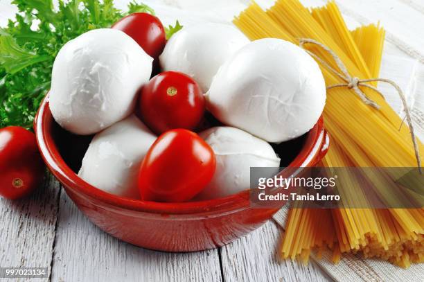 italian food mozzarella tomato spaghetti pasta on wooden background - tomato pasta stock pictures, royalty-free photos & images