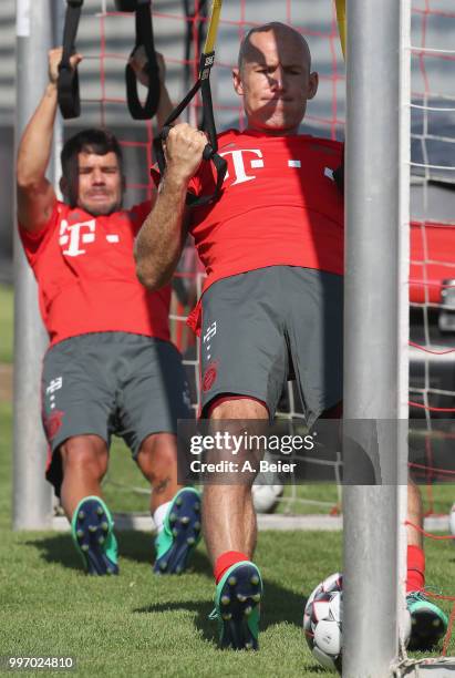 Juan Bernat and Arjen Robben of FC Bayern Muenchen practice during a training session at the club's Saebener Strasse training ground on July 12, 2018...