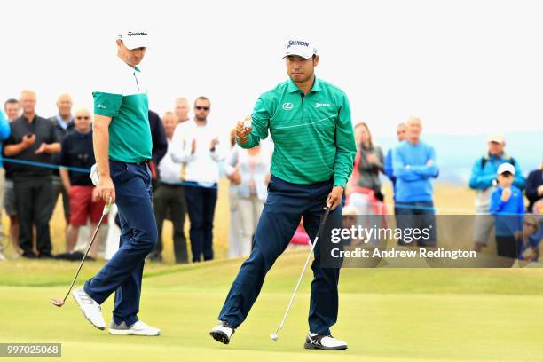 Hideki Matsuyama of Japan and Justin Rose of England line up their putts on hole sixteen during day one of the Aberdeen Standard Investments Scottish...