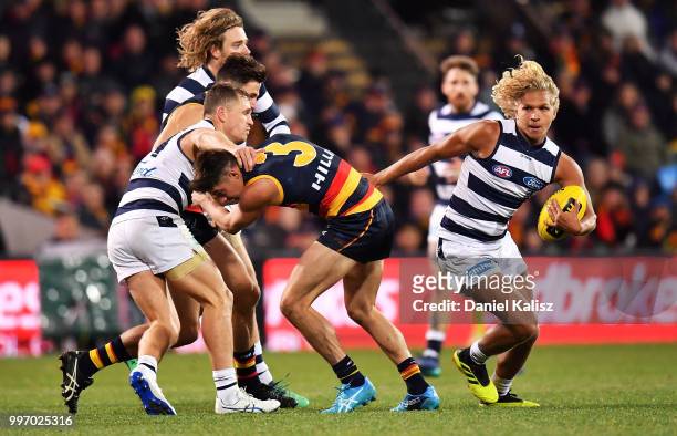 Quentin Narkle of the Cats runs with the ball during the round 17 AFL match between the Adelaide Crows and the Geelong Cats at Adelaide Oval on July...