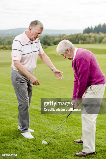 Mark Stevenson, golf coach and PGA professional can be seen teaching his oldest pupil, Heinz at the Golf club Gut Rieden In Starnberg, Germany, 27...