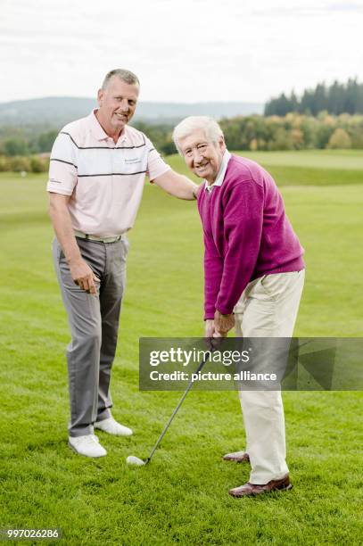 Mark Stevenson, golf coach and PGA professional can be seen teaching his oldest pupil, Heinz at the Golf club Gut Rieden In Starnberg, Germany, 27...