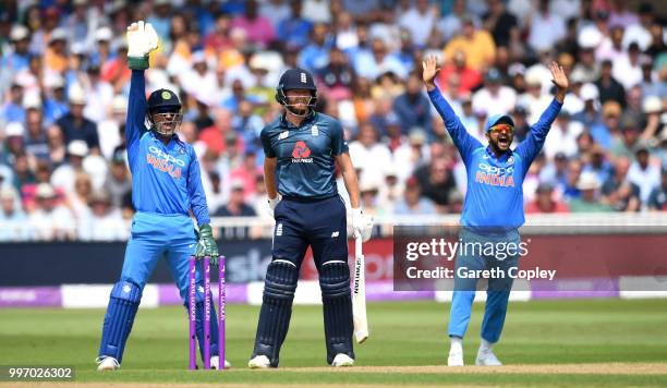 Dhoni and Suresh Raina of India successfully appeal for the wicket of Jonathan Bairstow of England during the Royal London One-Day match between...