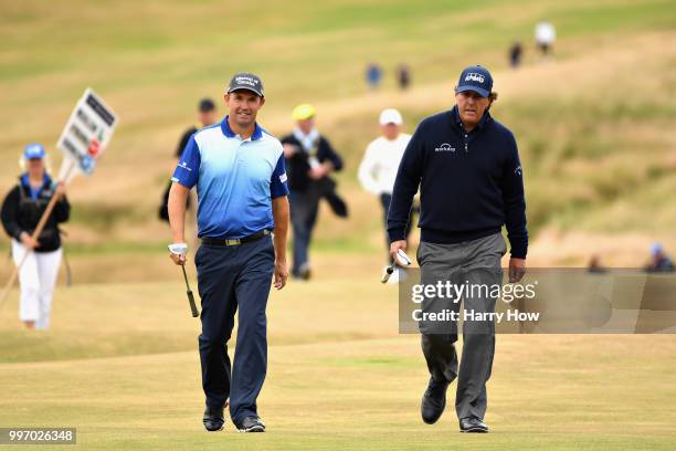 Phil Mickelson of USA and Padraig Harrington of Ireland walk on hole eighteen during day one of the Aberdeen Standard Investments Scottish Open at...