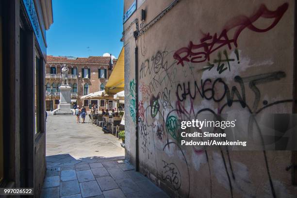 Graffiti and tags are seen on a wall of a calle that leads to Campo Santo Stefano, close to Accademia bridge, on the way that connect St. Mark square...