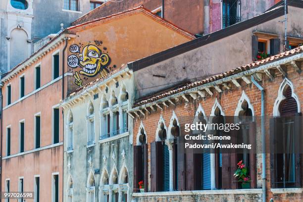 Graffiti is seen on a palace along the Cannaregio canal, on the way that connects railway station S. Lucia to Rialto bridge, through Cannaregio...