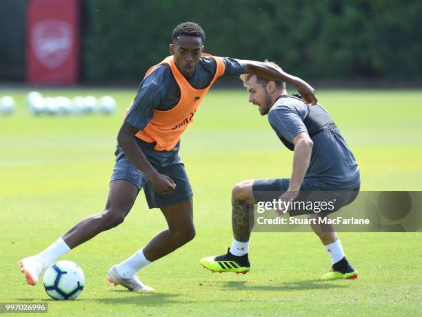 Joe Willock and Aaron Ramsey of Arsenal during a training session at London Colney on July 12, 2018 in St Albans, England.